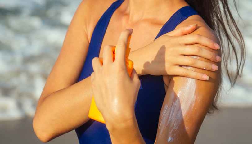 a girl applying sunscreen